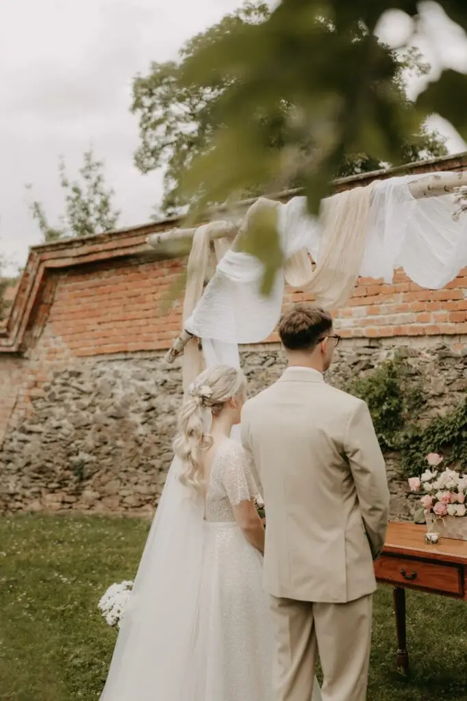 a man and woman standing under a canopy | A tak se stalo | Svatby | Svatební agentura Olomouc